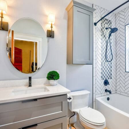 A white toilet and sink in a bathroom.