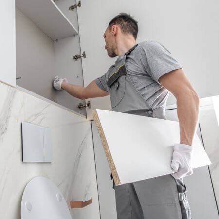 Man Fixing Bathroom Furnishing in the House