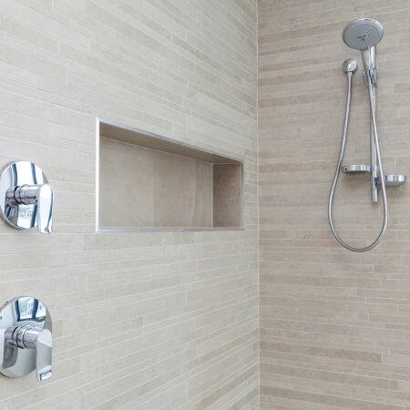 A close-up of a shower head in a bathroom.