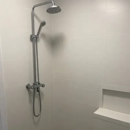 Modern shower fixture installed during a Kansas City bathroom remodel.